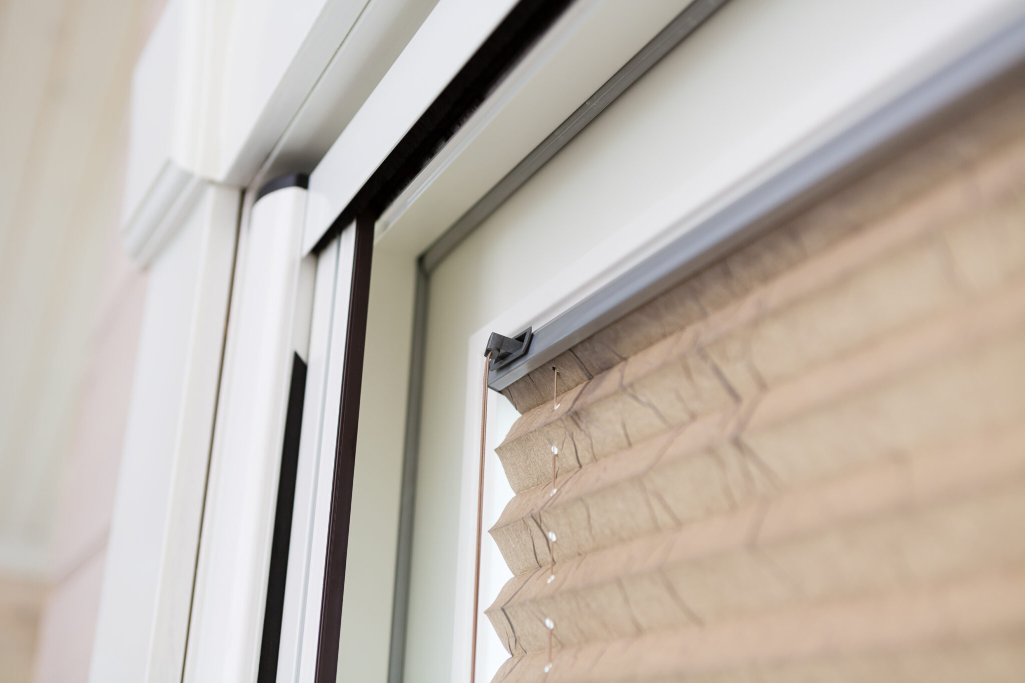 Close-up detail of a door frame with a retractable insect screen system, showing the slim casing and mesh integrated neatly into the doorway